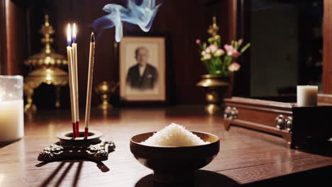 spiritual offering with candles, incense and rice