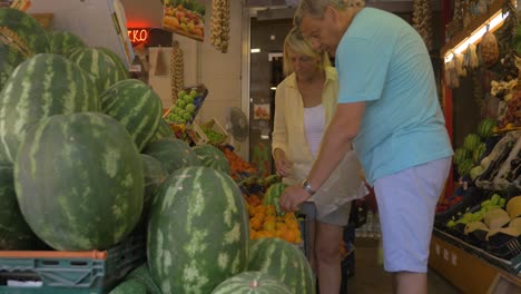 Mature-Couple-Choosing-Fruit-in-Grocery-Store