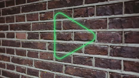 animación del icono del botón de reproducción de neón brillante en la pared de ladrillo