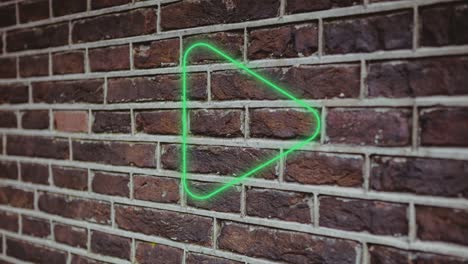 animation of glowing neon play button icon on brick wall