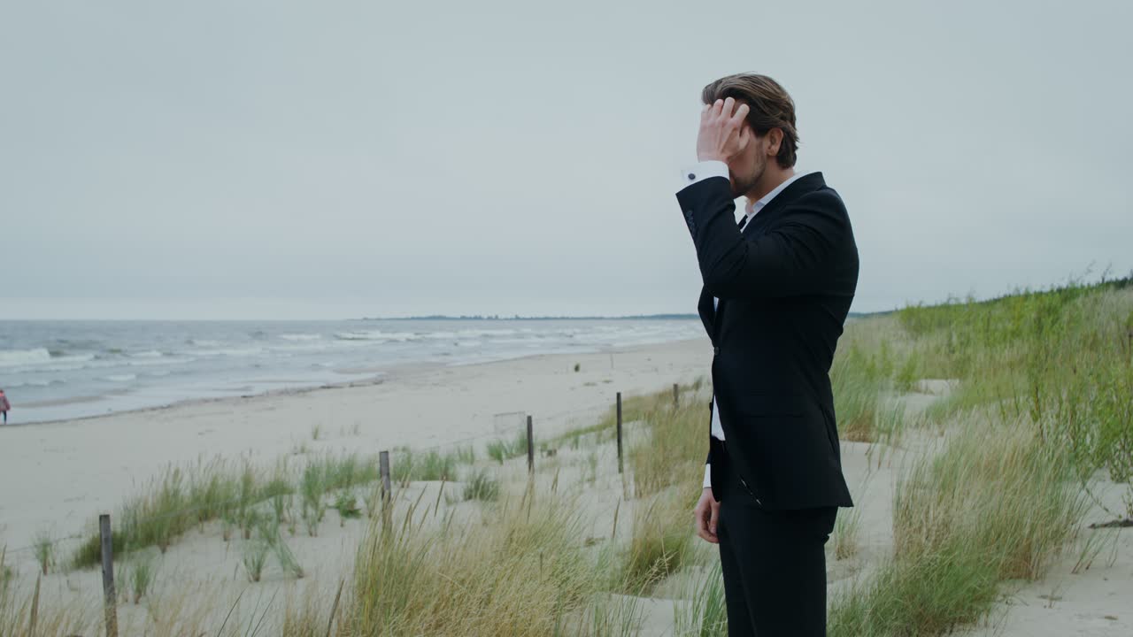 Man in suit on the beach