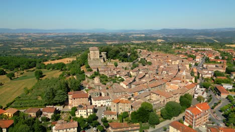 castello di sarteano, a picturesque medieval village in tuscany, italy, showcases its historic architecture and surrounding landscape under a clear blue sky