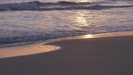 Olas-En-La-Playa-De-Arena-Que-Reflejan-El-Amanecer,-Costa-Tranquila,-Costa-Blanca,-España