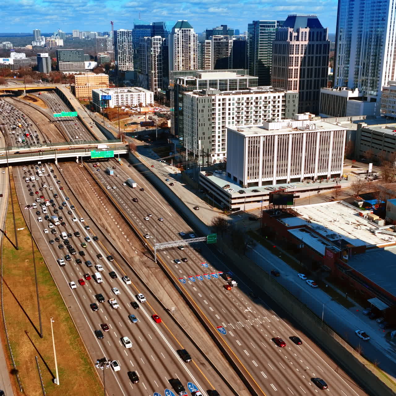 Flight above the highways with busy traffic. Top view on the downtown of Atlanta, Georgia, USA on sunny autumn day.