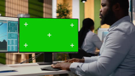 technician works on power line tower cad design on green screen pc in office