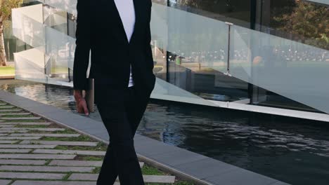 businessman with laptop walking in the city