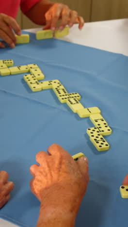 senior friends playing dominos