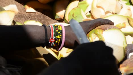 coconut vendor opening coconut with traditional knife - close up