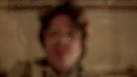 blurred reflection of a person through textured glass