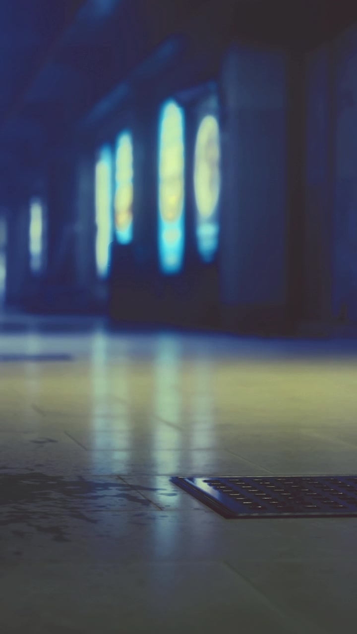 Light reflections in a dim hallway with posters and wet floor