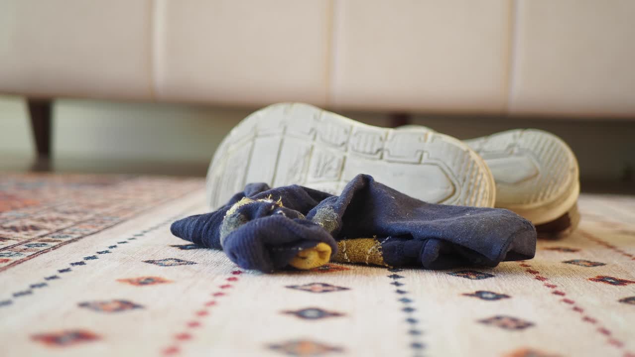 A pair of socks and shoes on a rug | Premium Stock Video Footage