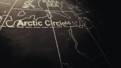 close-up of the arctic circle on a vintage globe