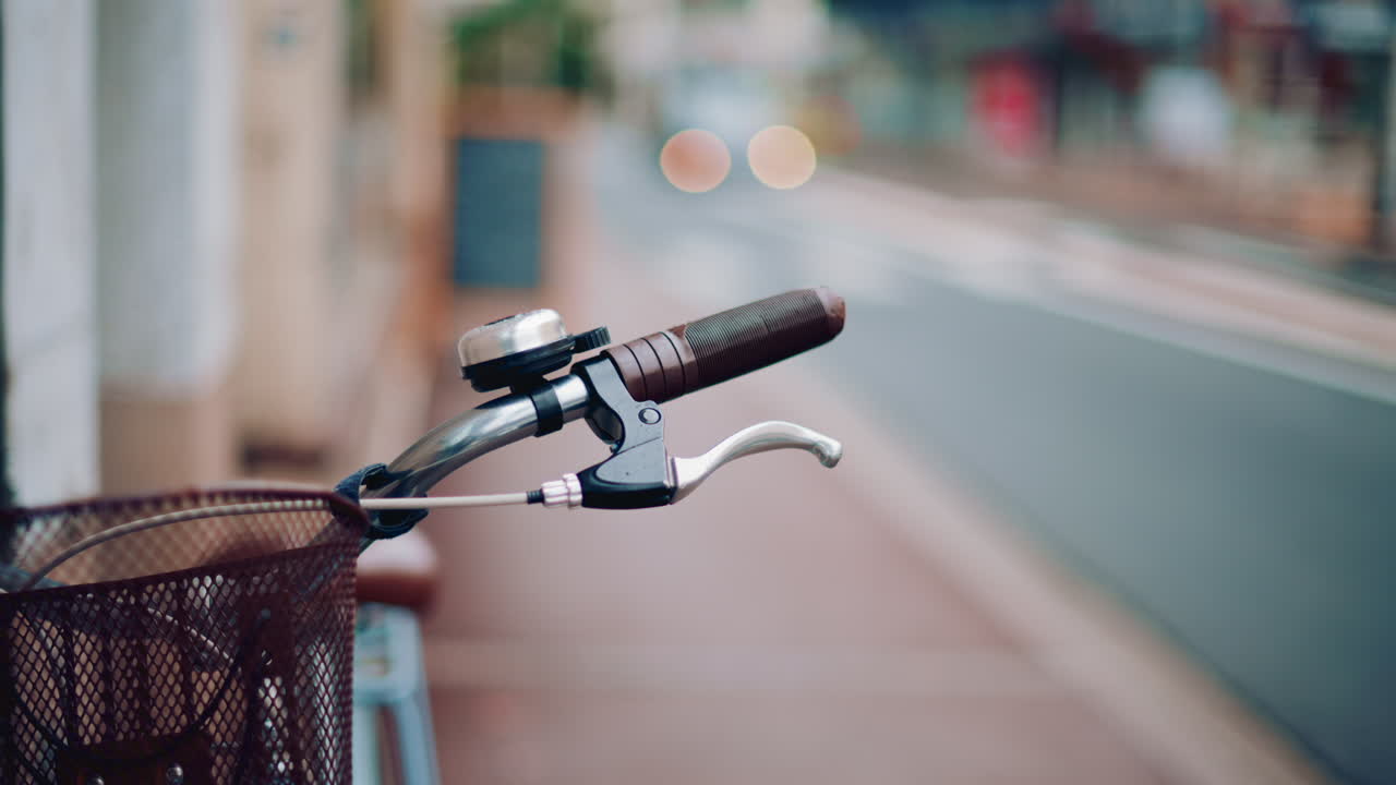 Close up of a bicycle handle and bell in an empty street