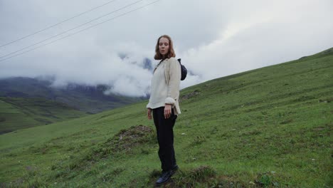 woman in a field with a mountain view.