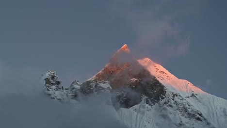 snowcapped mountains summit background at sunset with copy space, pointy pointed mountain top in beautiful dramatic last light at sunset, tall high big massive mountain peaks background