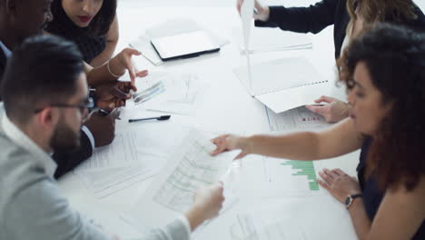 a group of businesspeople going through paperwork