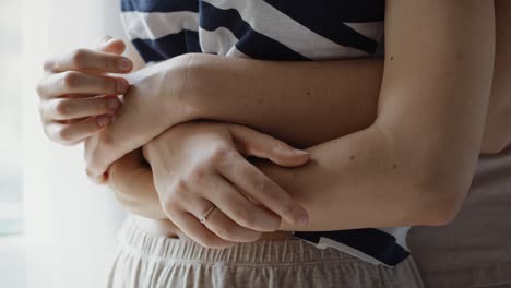 close up video of lesbian couple hugging on the bedroom.