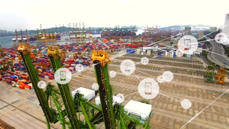 network of digital icons against aerial view of sea port warehouse