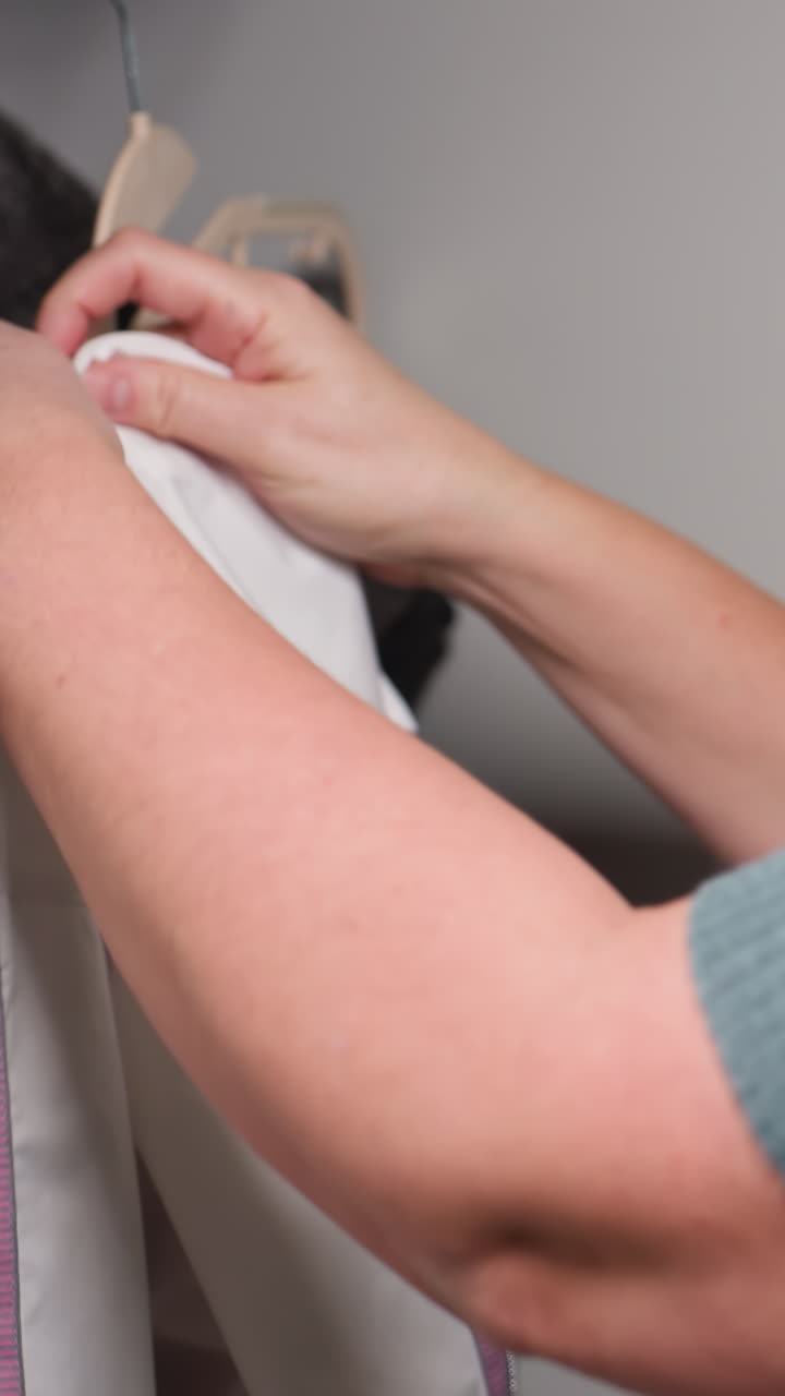 Clothing check detailed, Careful examination process for garments and clothing articles thoroughly, Detailed and precise inspection procedure for clothing items stored in closet or wardrobe