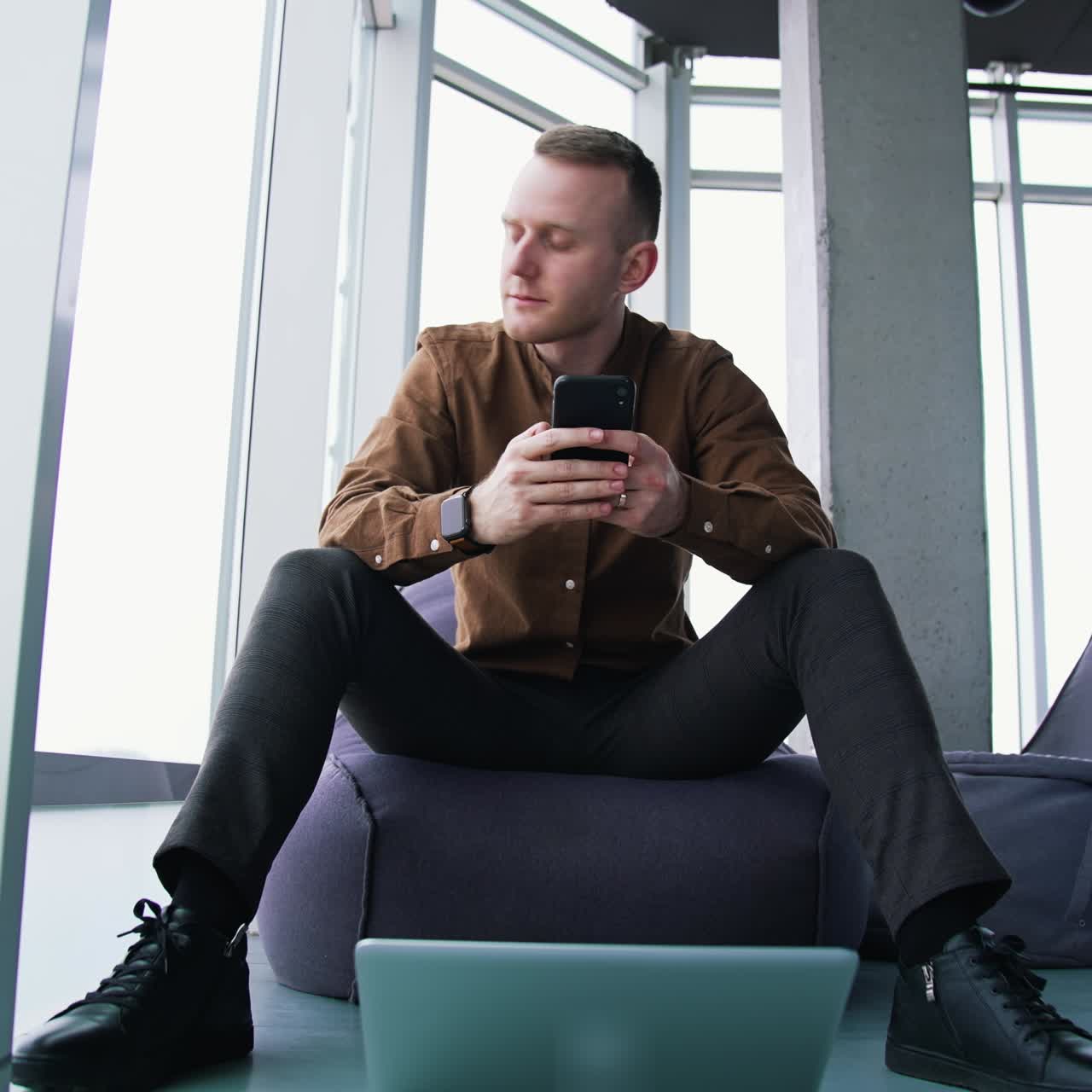 Young man with laptop and mobile phone. Man an is working remotely