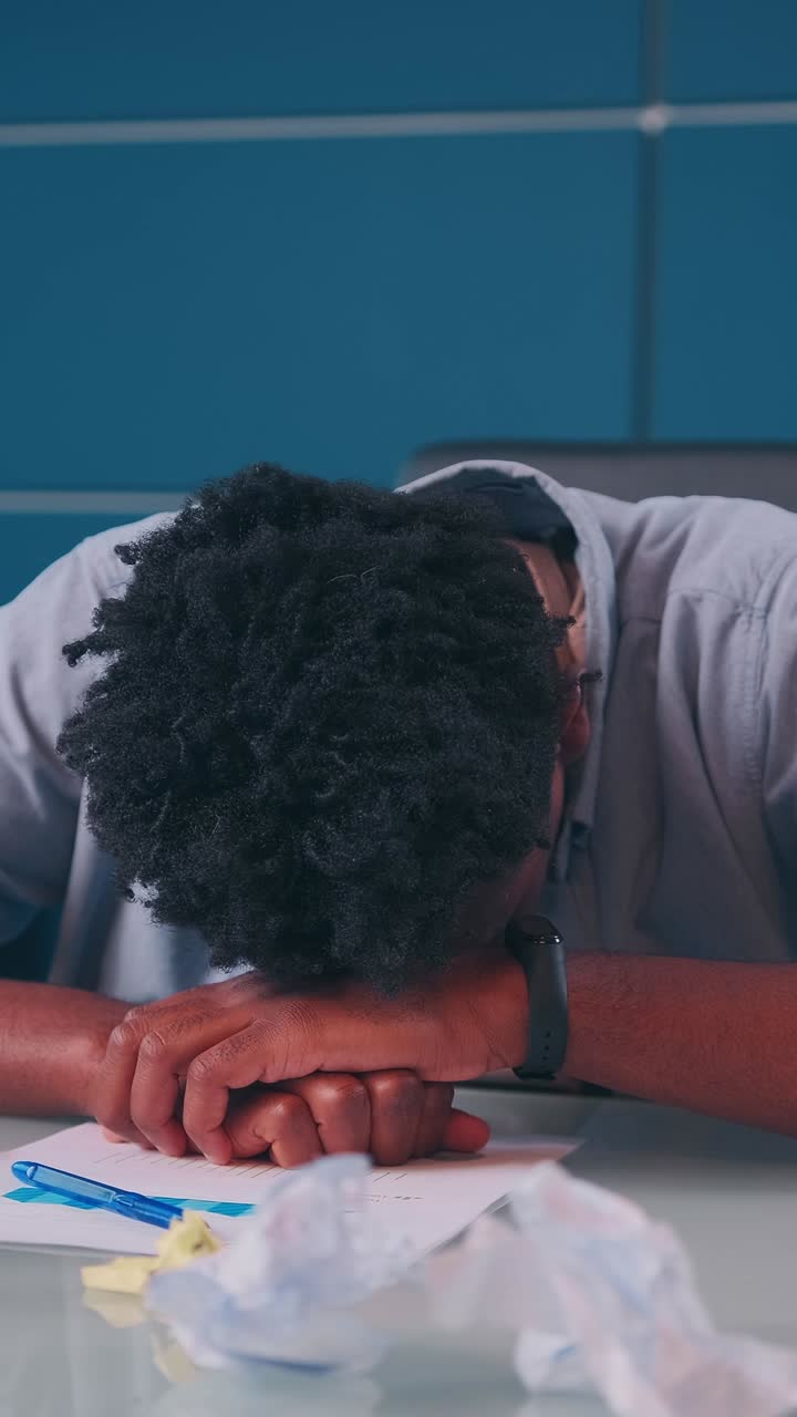 Overwhelmed student struggles with stress in a cluttered study space