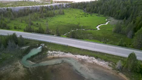 Aerial-view-of-quarry-water-empying-into-Lake-Huron,-Michigan