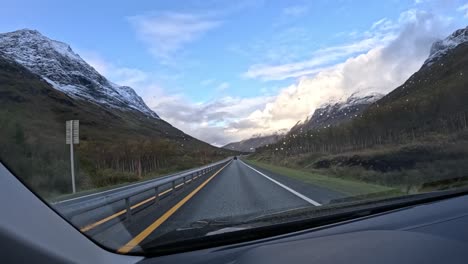 scenic drive through the rainy mountain roads near tromsø, norway, captured from a gopro hero 12 attached to a car window. the footage showcases the dramatic natural beauty of northern norway.