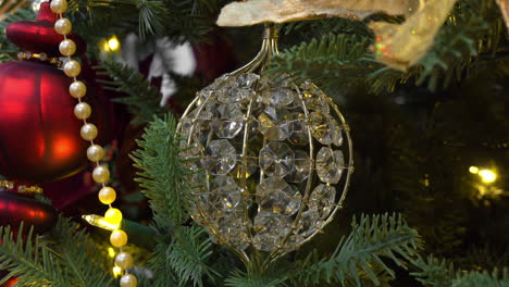 close up of beautiful crystal and red ornaments adorning a christmas tree