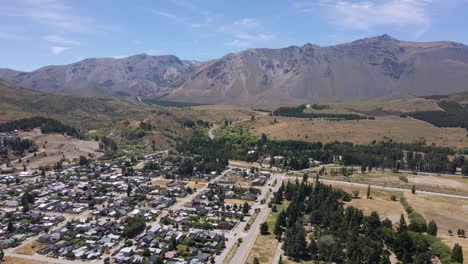 Dolly-in-flying-above-Esquel-valley-with-Andean-mountain-in-background,-Patagonia-Argentina