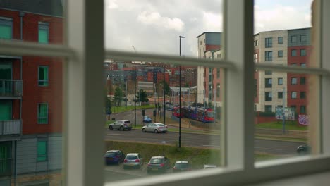 city view from a window: tram and traffic on a cloudy day