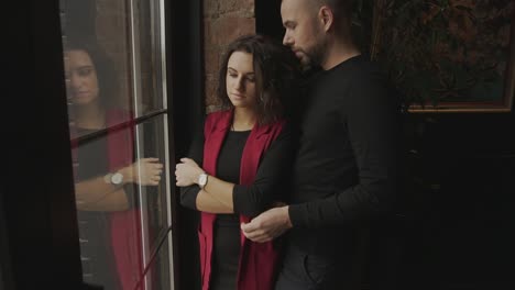 una pareja enamorada junto a la ventana.