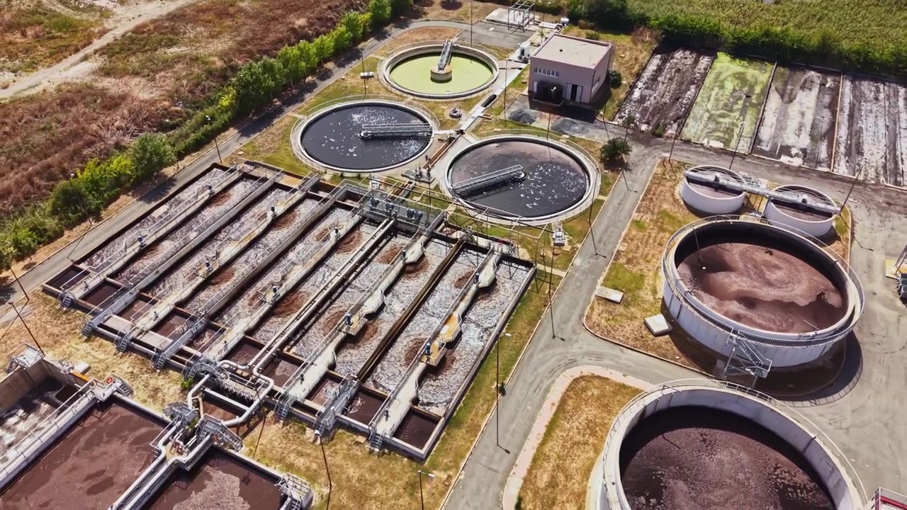 Water treatment facility located in a rural area showing multiple processing tanks and equipment for treating water