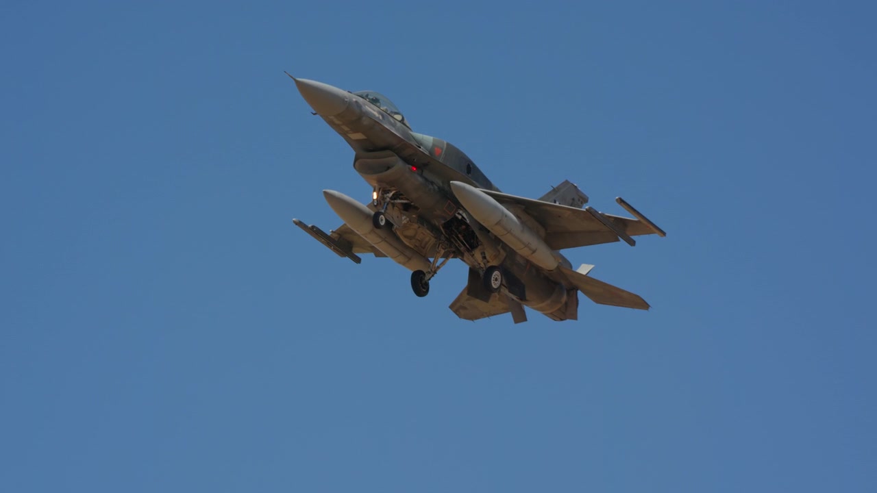 Fighter jet banking overhead underside view