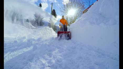 man clearing snow with snow blower 4k