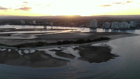 Rising up to reveal sandbar at sunset on Gold Coast, low tide