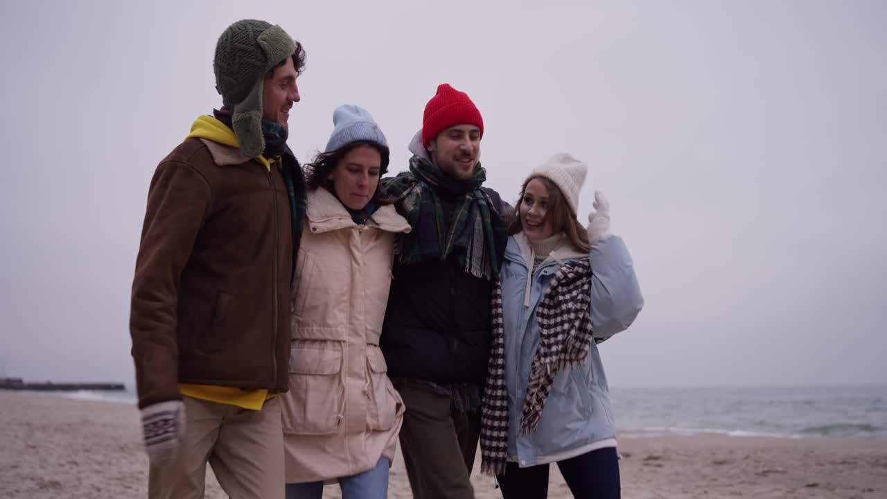 Friends enjoying a winter walk on the beach