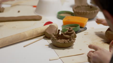 kids work with ceramics at pottery workshop