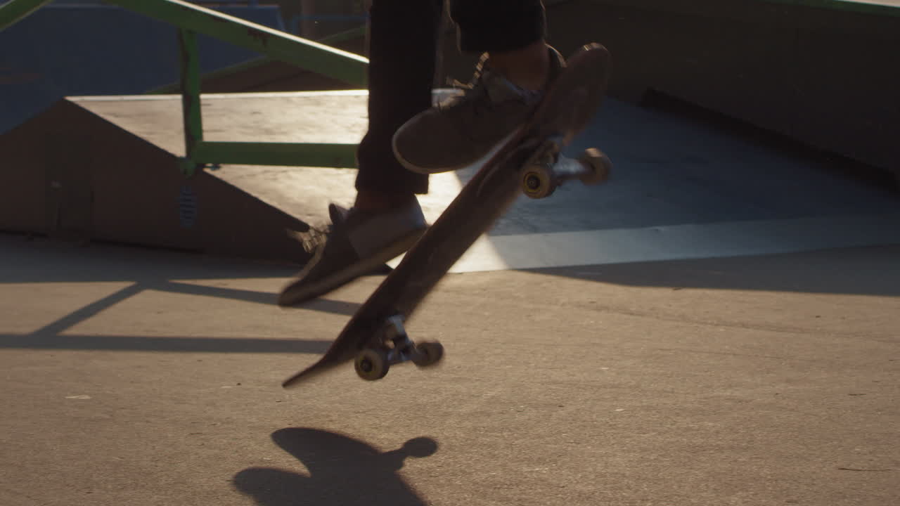 Slowmo of Unrecognizable Skater Doing Kickflip