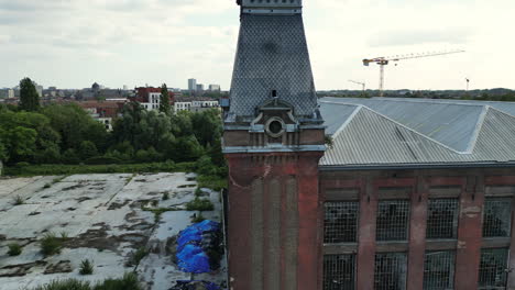 fast backward aerial moving away from tower with clock in ghent