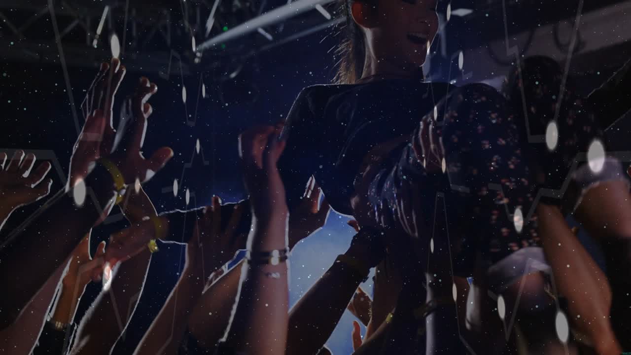 Female performer concert crowd-surfing, fans lifting her, rising and singing into mic to stage