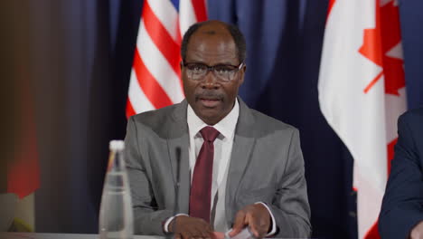 african american politician talking with journalist at press conference