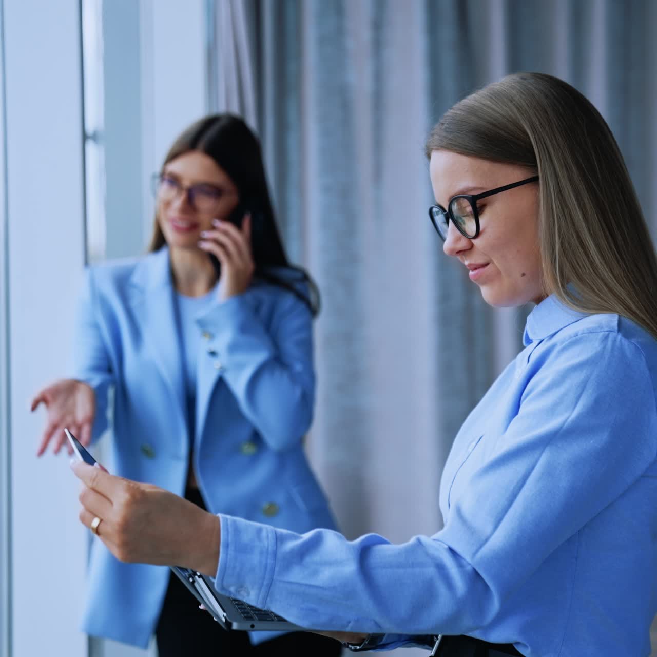 Succesfull young businesswoman standing with laptop. Beautiful business manager working with computer