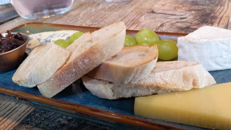 elegant cheese board with cheddar camembert blue cheese rustic bread and chutney