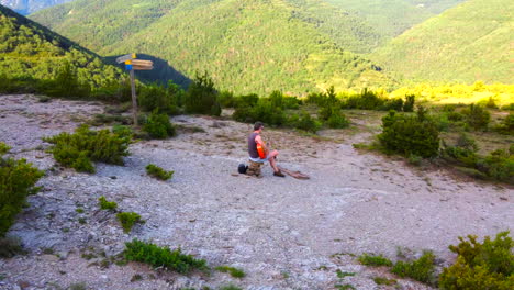 Man-playing-classical-guitar-in-the-nature-between-mountains