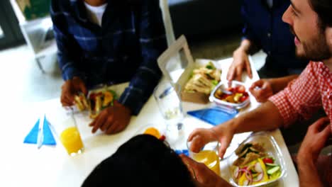 Happy-executives-interacting-while-having-breakfast