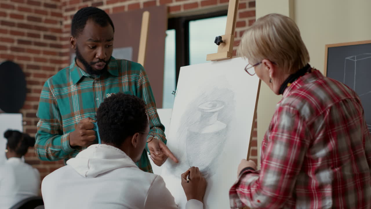 Teacher and team of students talking about vase drawing on canvas