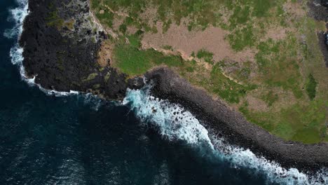 rocky shore of cook island in new south wales, australia - aerial top down