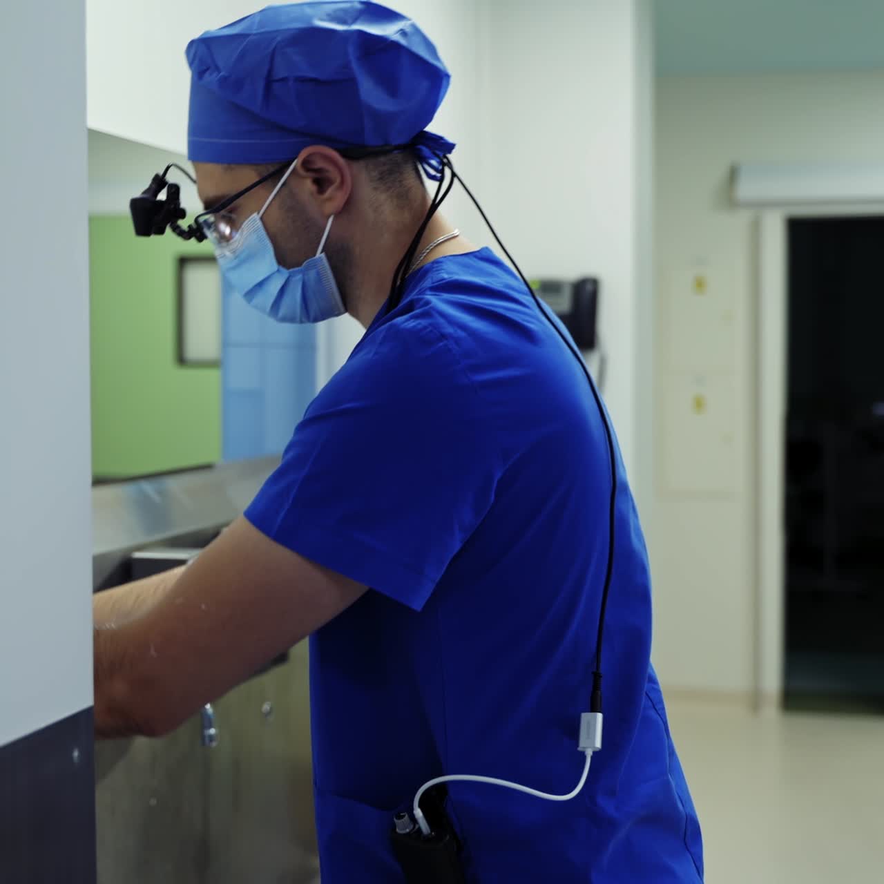Disinfection procedure in clinic. Surgeon washes his hands thoroughly before the operation. Male doctor washing hands before surgery. Quarantine. Covid-19