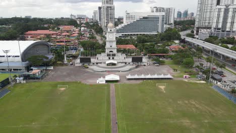 Aerial-Drone-Pullout-Shot-Low-Angle-of-Jam-Besar-Dataran-in-Johor-Bahru,-Malaysia