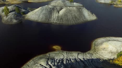 aerial view of an abandoned quarry with lakes and hills